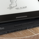 The Onyx Boox Leaf 2 e-reader sitting atop the Kobo Libra on a wooden table.